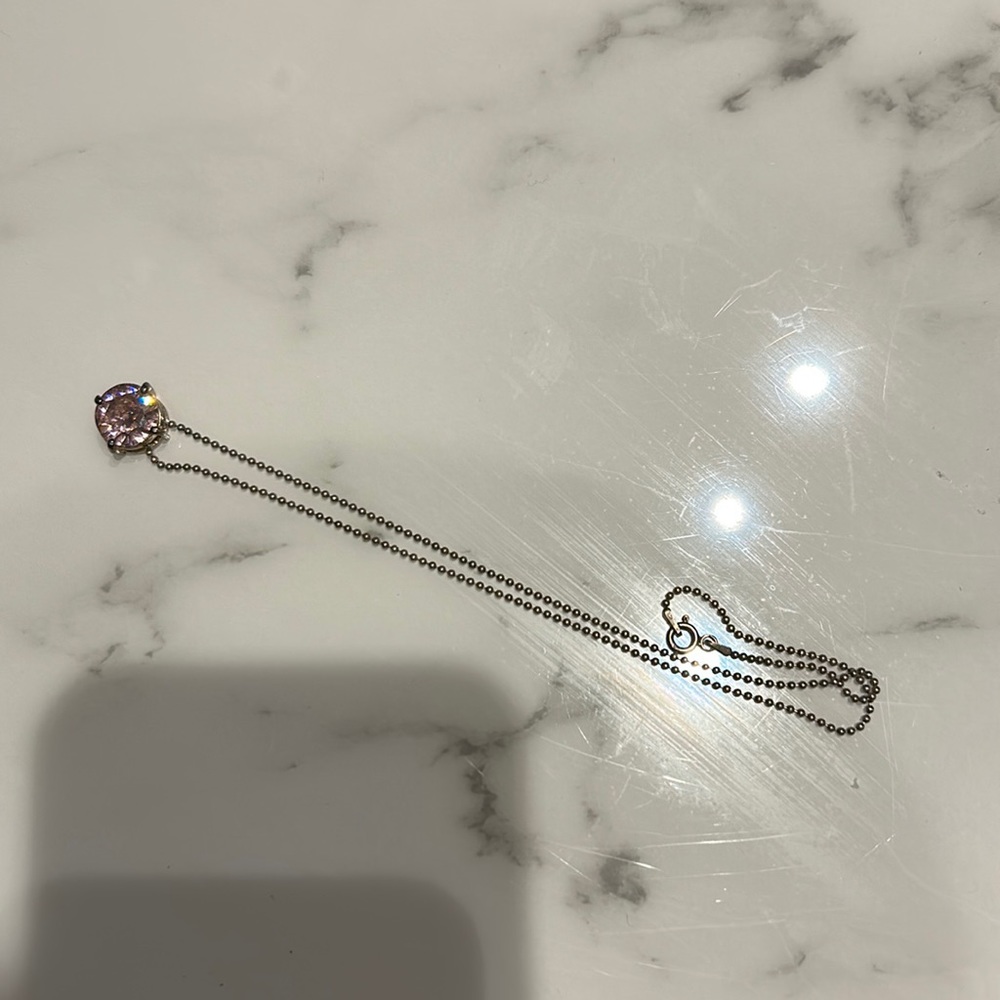 Cute pink necklace. Stone is about the size of my pinky. Super dainty chain.